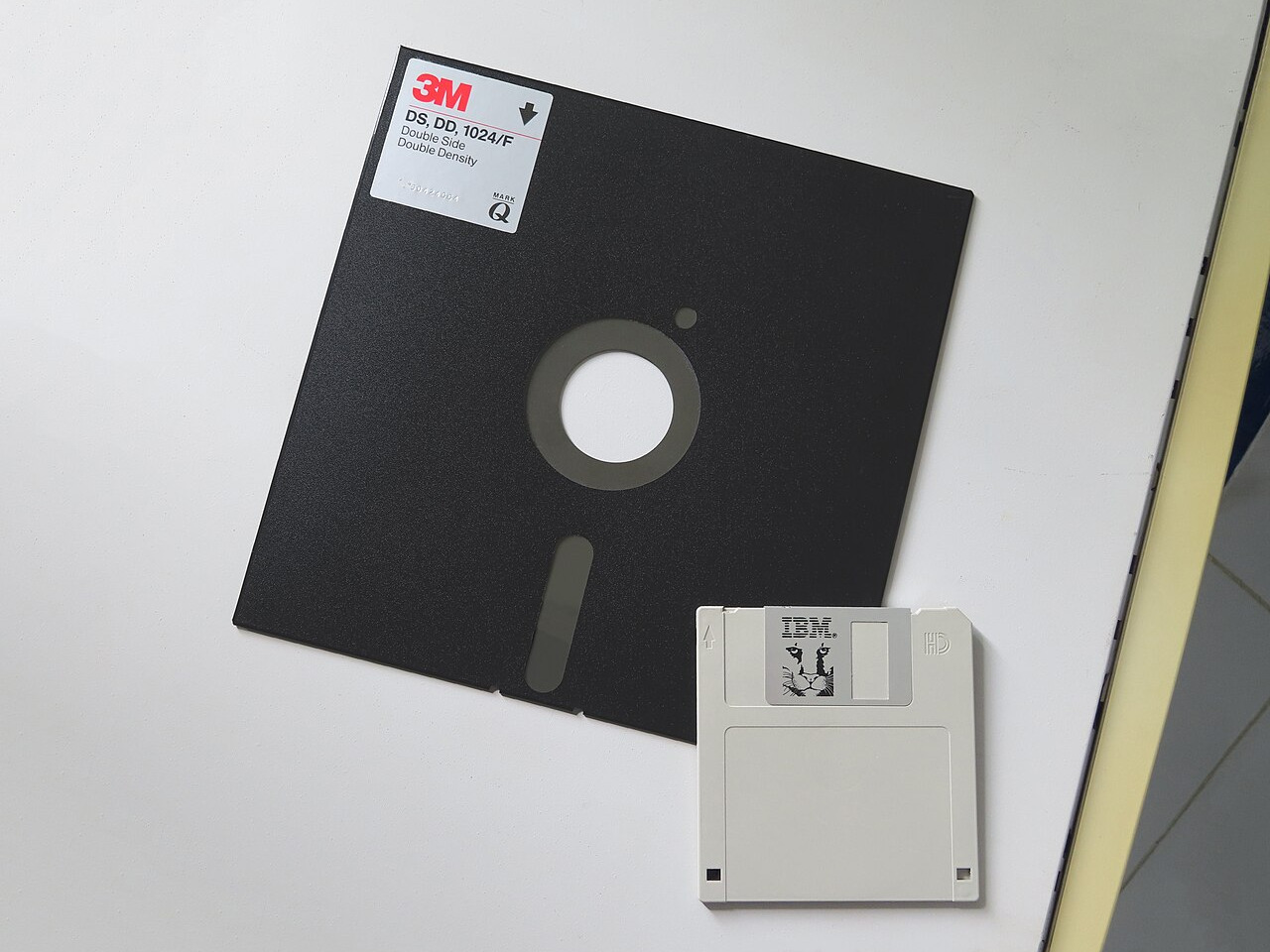 An 8 inch floppy disk compared to a 3.5 inch floppy disk